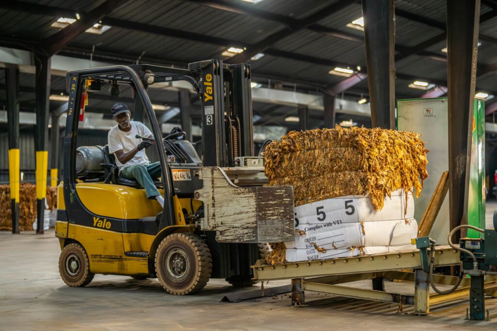 Forklift operator moving material in an industrial warehouse