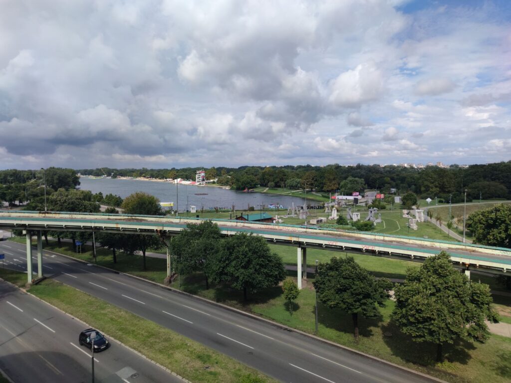Highway and overpass beside a lake in daylight